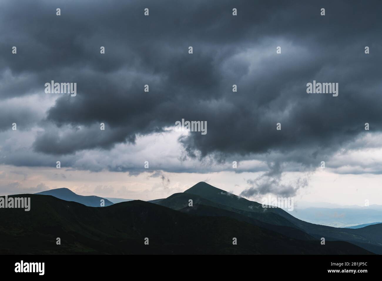 Amazing flowing rainy clouds in evening mountains. Beautiful nature of Carpathians. Landscape photography Stock Photo