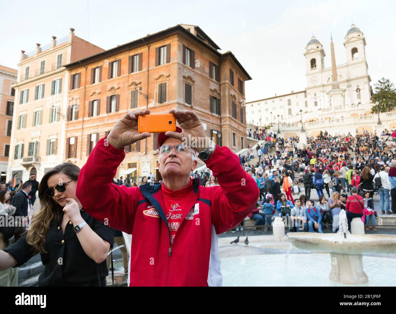 Senior man takes a selfie photo at Fontana della Barcaccia in Rome, Italy Stock Photo