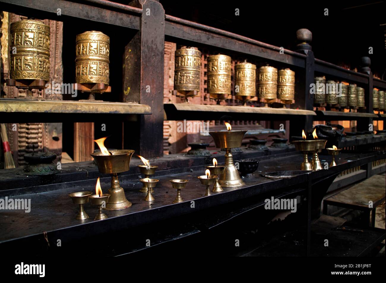 Burning butter lamps in a buddhism temple in Kathmandu, Nepal Stock Photo