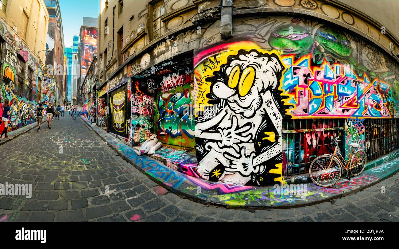 Cartoon painting and graffiti covered walls, down cobbled stoned alley ways, Hosier Street, Melbourne Lanes, Melbourne, Victoria, Australia Stock Photo