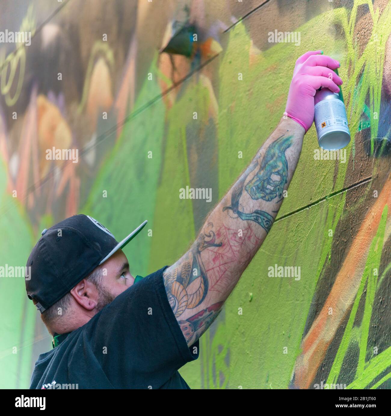 Man with spray can, spray painting graffiti, Hosier Street, Melbourne Lanes, Melbourne, Victoria, Australia Stock Photo