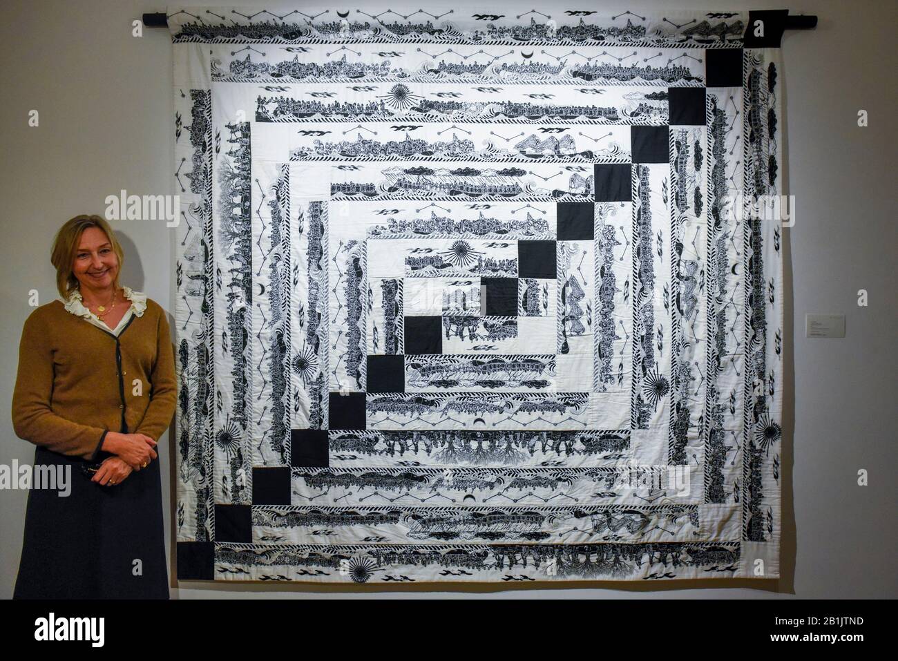 London, UK. 26 February 2020. Artist Cath Kidston poses with Ai Wei Wei's  Odyssey in Quilting, 2019 (Starting price GBP70,000). Preview of Human  Touch, an exhibition of one-of-a-kind artworks by international  contemporary