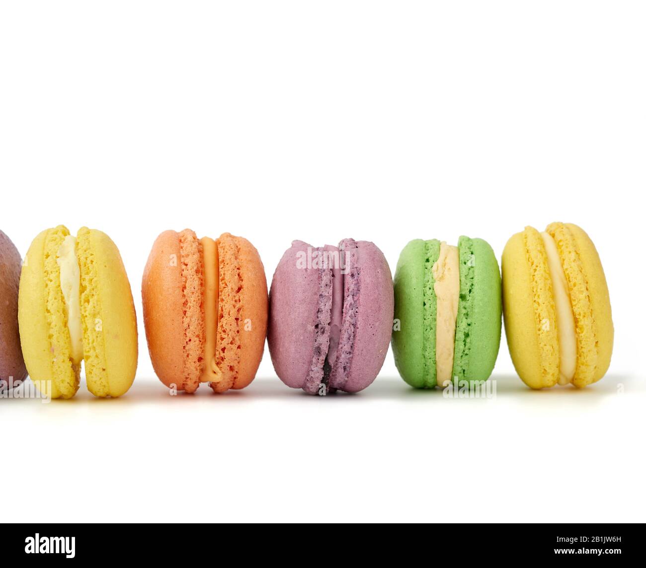 multicolored round baked macaroon cakes isolated on a white background ...