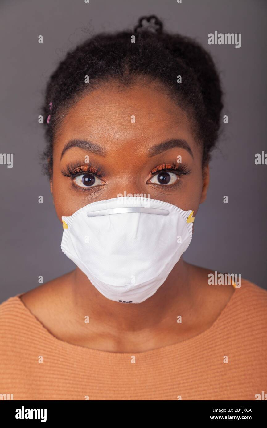 Young woman wearing protective face mask Stock Photo