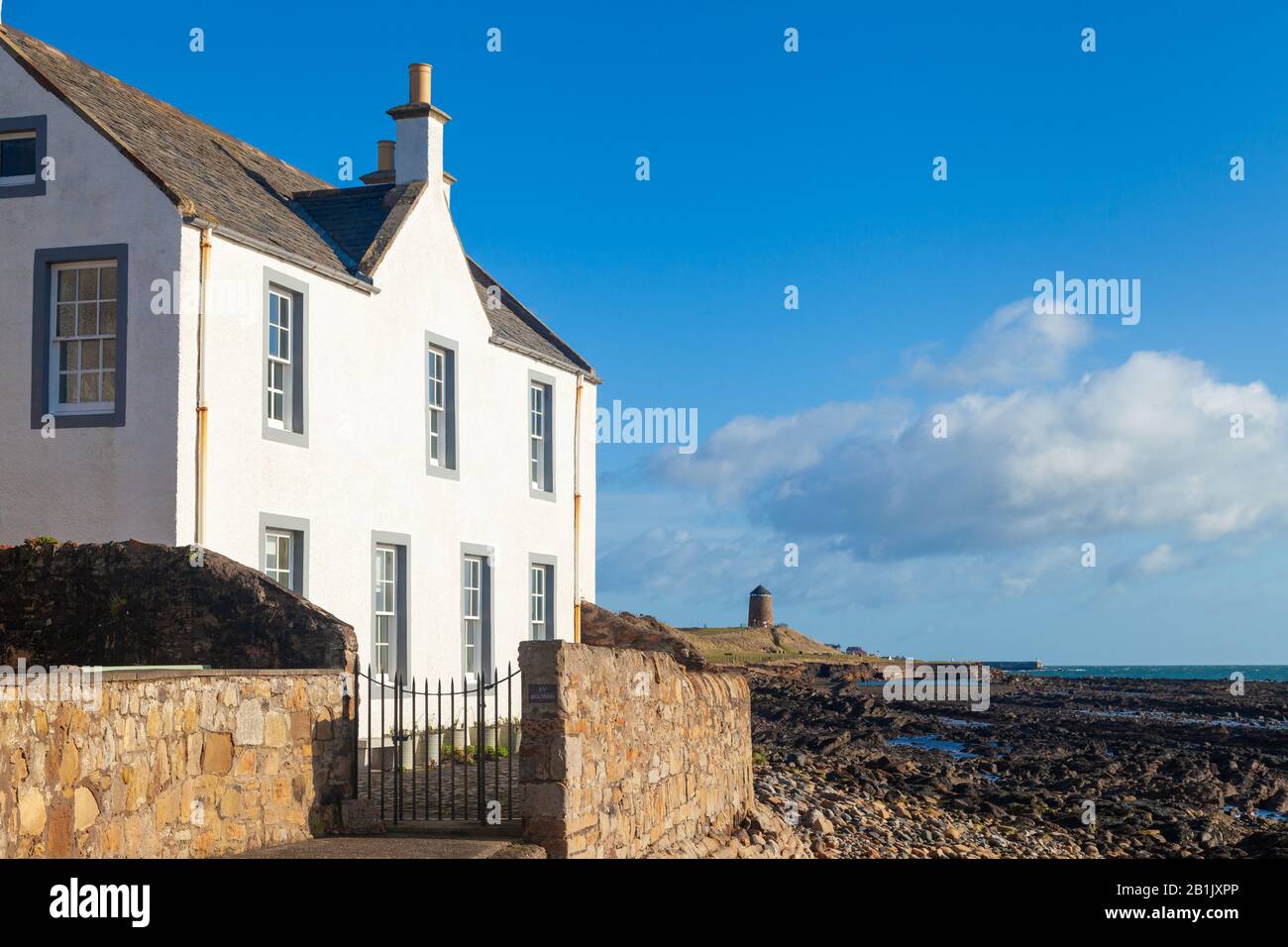 Traditional Fife house along the Fife Coastal Path with the windmill in the background, St Monans Fife Scotland. Stock Photo