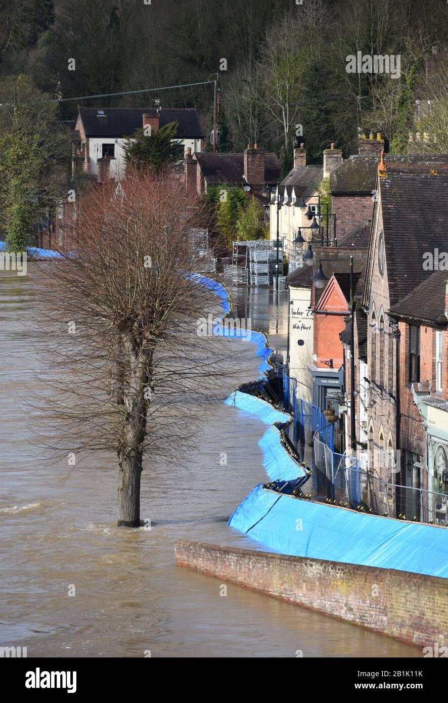 Temporary flood barriers which have been moved by the River Severn ...