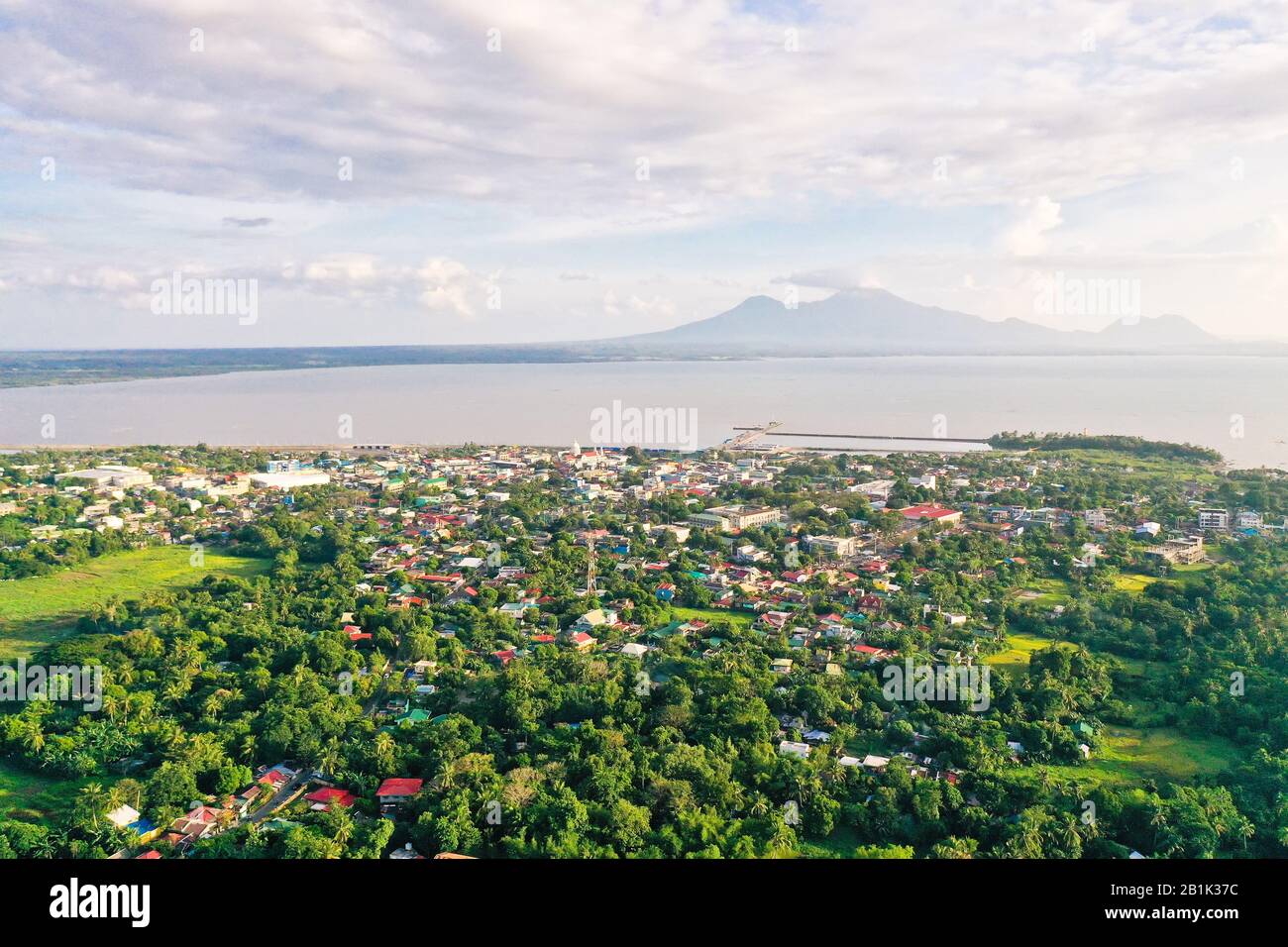 Sorsogon City, Luzon, Philippines. Town by the sea, top view. Landscape in Asia. Summer and travel vacation concept. View of a small town and a volcano in the distance. Stock Photo