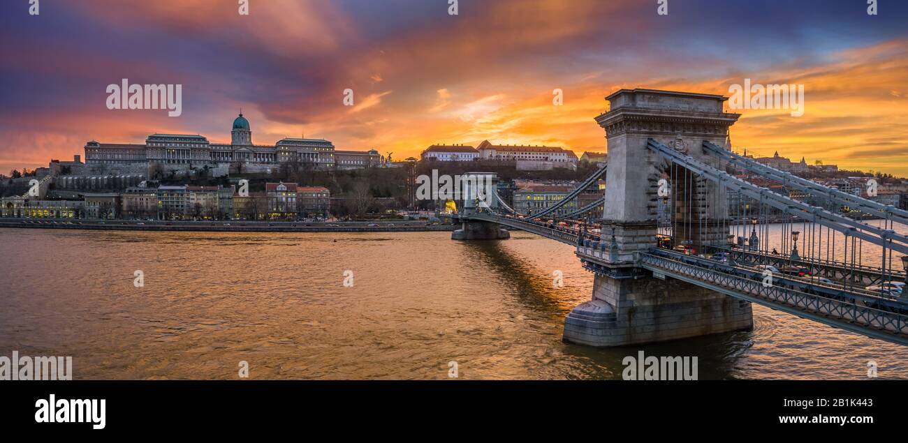Budapest, Hungary - Aerial panoramic view of Szechenyi Chain Bridge with Buda Tunnel and Buda Castle Royal Palace at background with a dramatic colorf Stock Photo