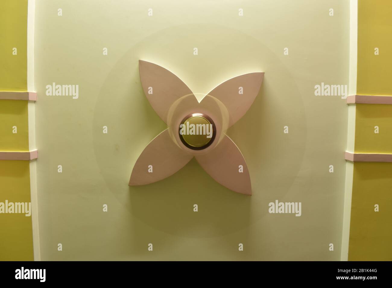 fan running on the designed plaster ceiling. electric fan moving on the