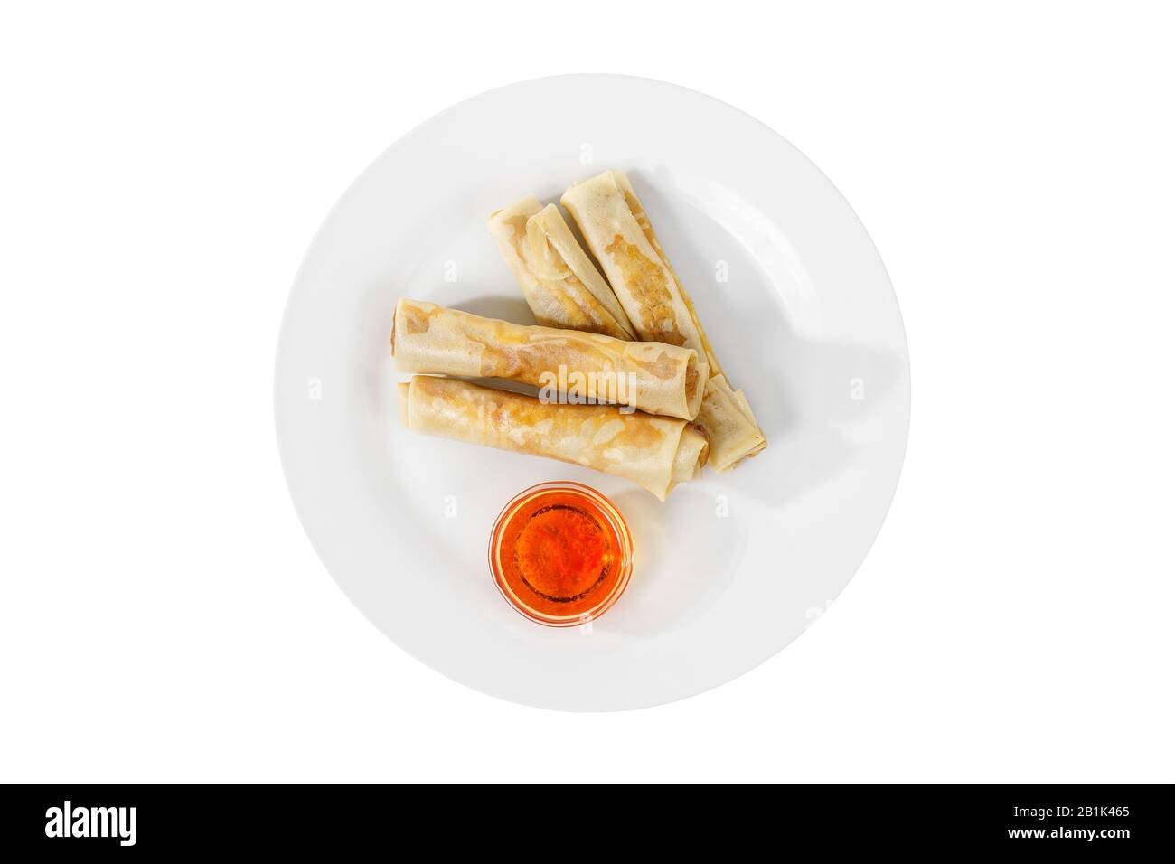Hot appetizer stuffed pancake on plate with hot red sauce, pepper, fried in oil before alcohol, white isolated background, view from above Stock Photo