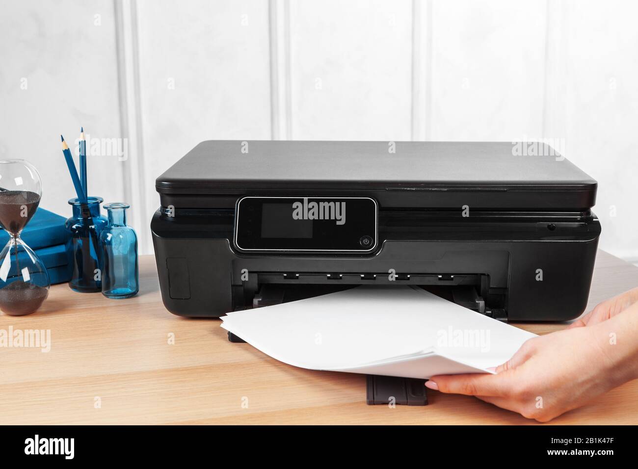 Female secretary making photocopies on xerox machine in office Stock