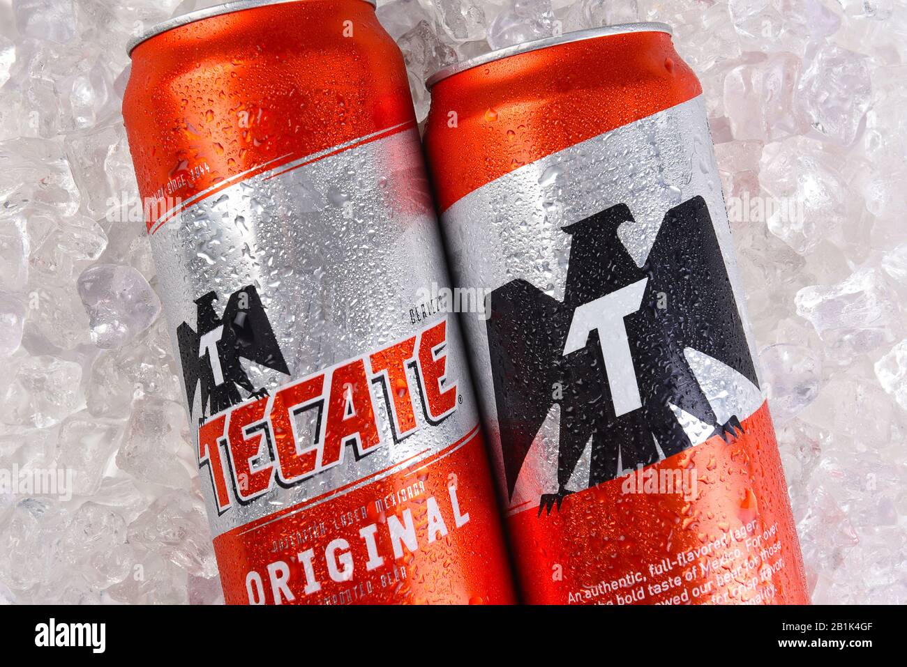IRVINE, CALIFORNIA - MARCH 21, 2018: Two Tecate Original Cerveza cans on ice closeup. Cuauhtemoc Moctezuma Brewery is a major brewer based in Monterre Stock Photo