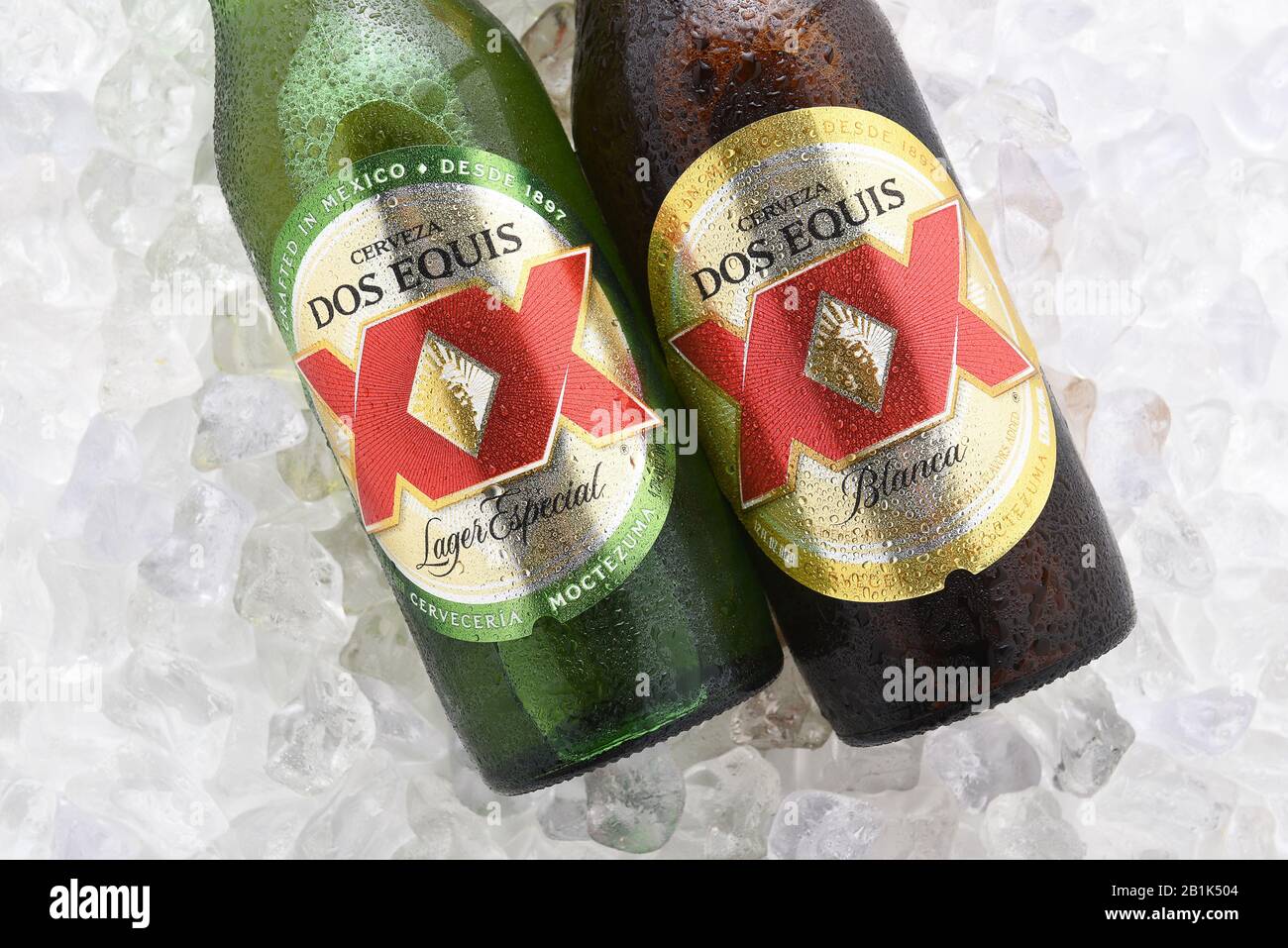 IRVINE, CA - JUNE 14, 2017: Dos Equis Blanca and Especial on ice. Two bottles the beer from Cuauhtemoc-Moctezuma Brewery in Monterrey, Mexico a subsid Stock Photo