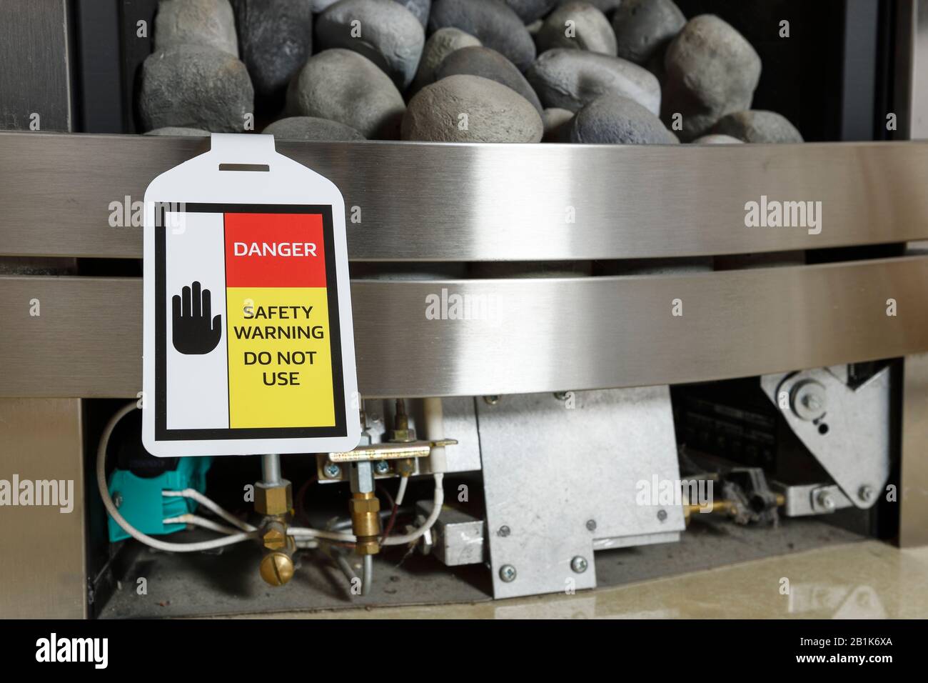 A Danger Safety Warning label attached to a UK domestic gas fire Stock Photo