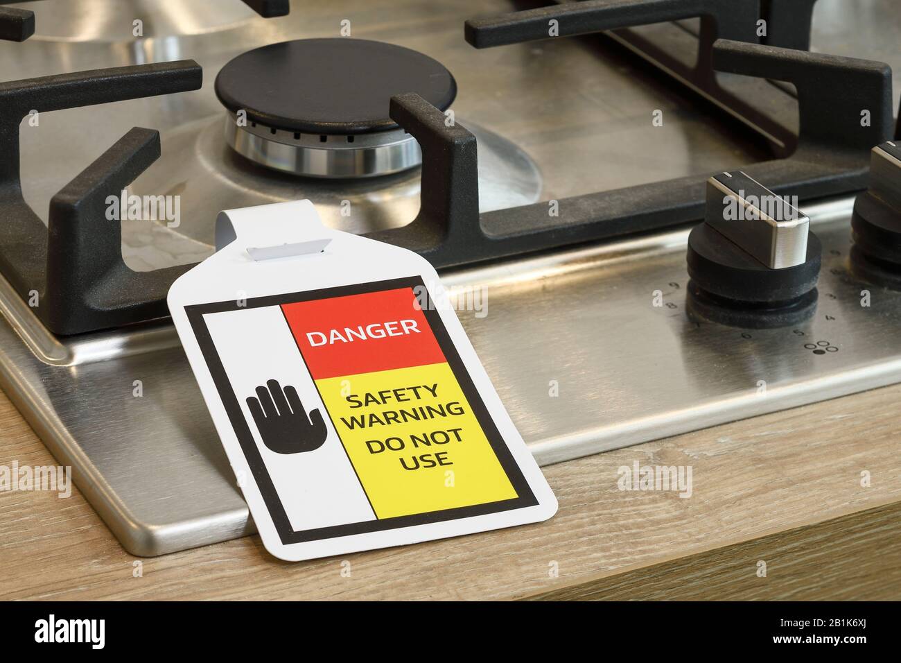 A Danger Safety Warning label attached to a UK domestic gas hob Stock Photo
