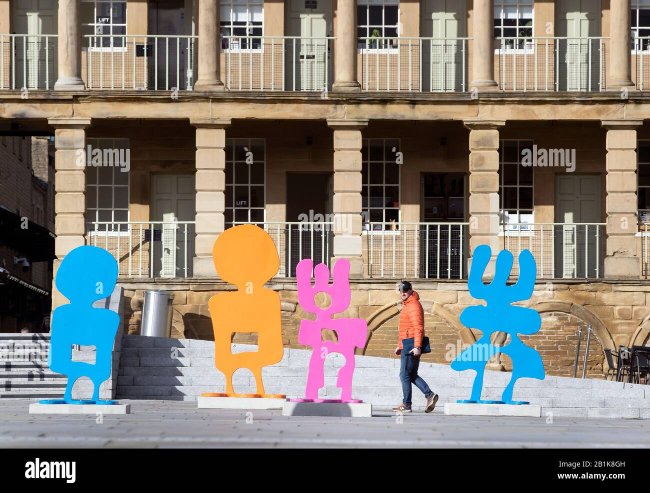 A member of the public views a installation titled People Play, by artist Alice Irwin, at the Piece Hall in Halifax. Stock Photo