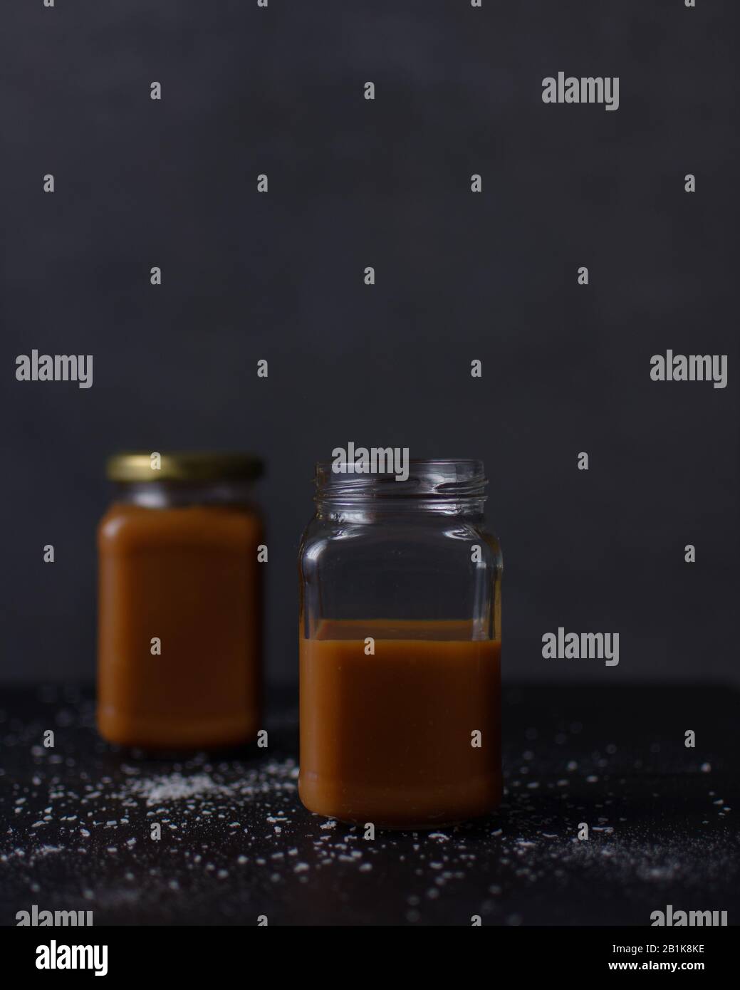 Glass jars of salted caramel sauce Stock Photo Alamy