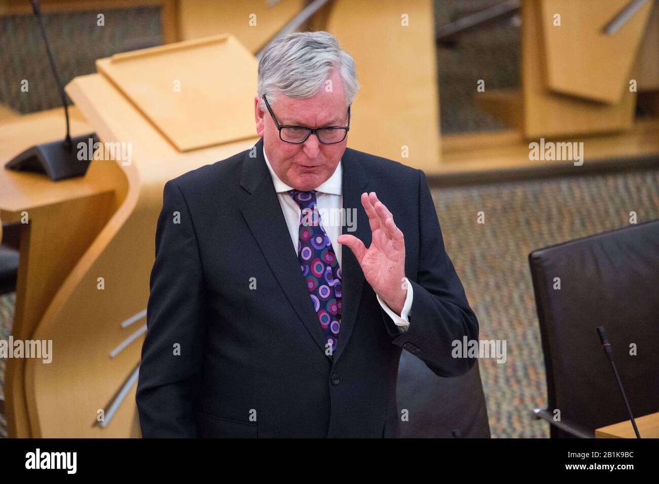 Edinburgh, UK. 26th Feb, 2020. Pictured: Fergus Ewing MSP - Cabinet Secretary for the Rural Economy. Ministerial Statement: Modernising and Empowering Scotland's Inshore Fisheries. Scenes from inside the debating chamber of the Scottish Parliament. Credit: Colin Fisher/Alamy Live News Stock Photo