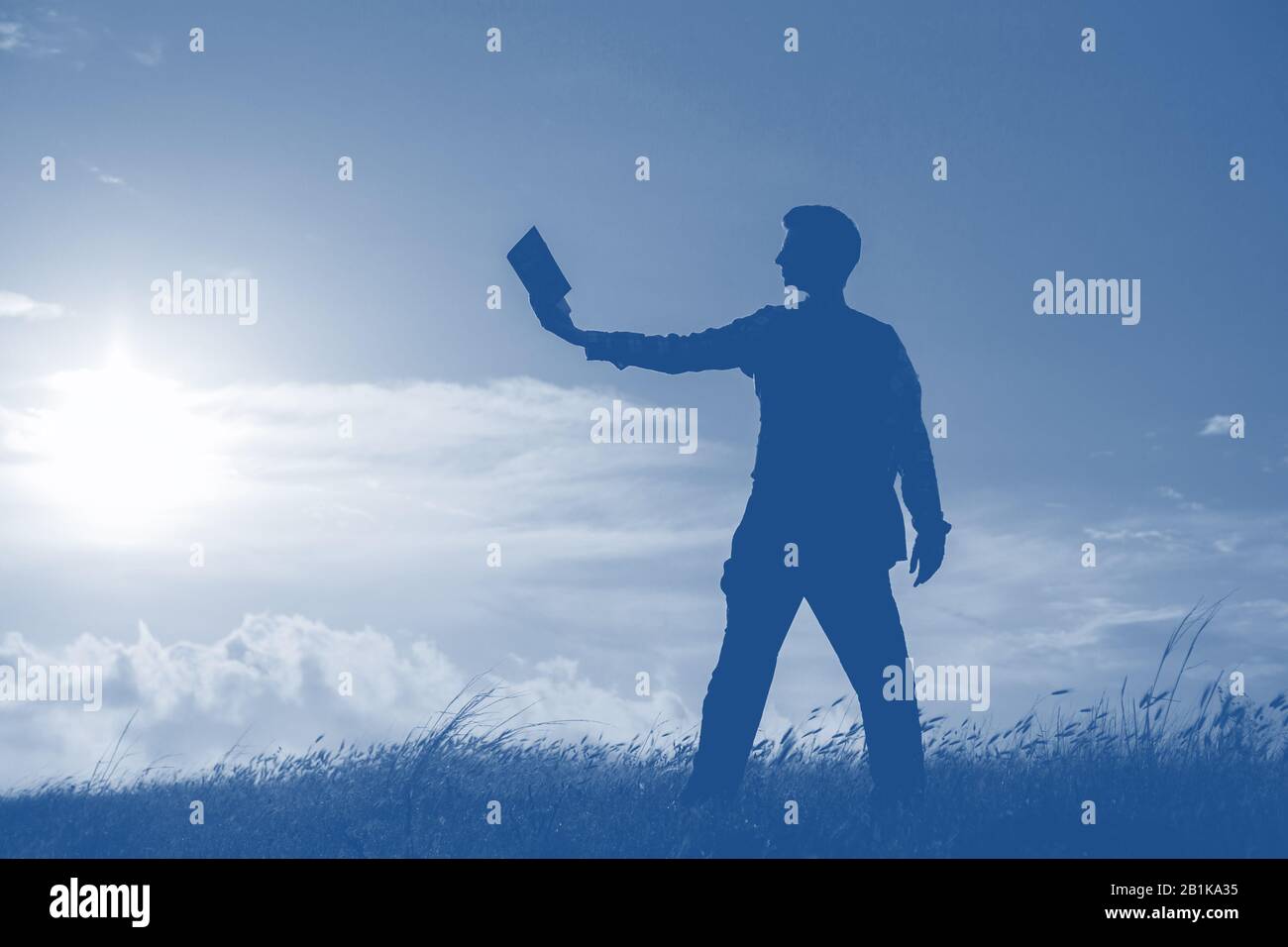 Silhouette of a men against beautiful romantic sunset sky with clouds ...