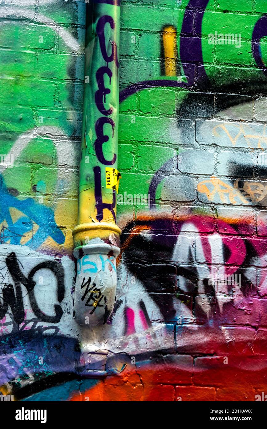 Graffiti covered brick wall and drain pipe, Hosier Street, Melbourne Lanes, Melbourne, Victoria, Australia Stock Photo