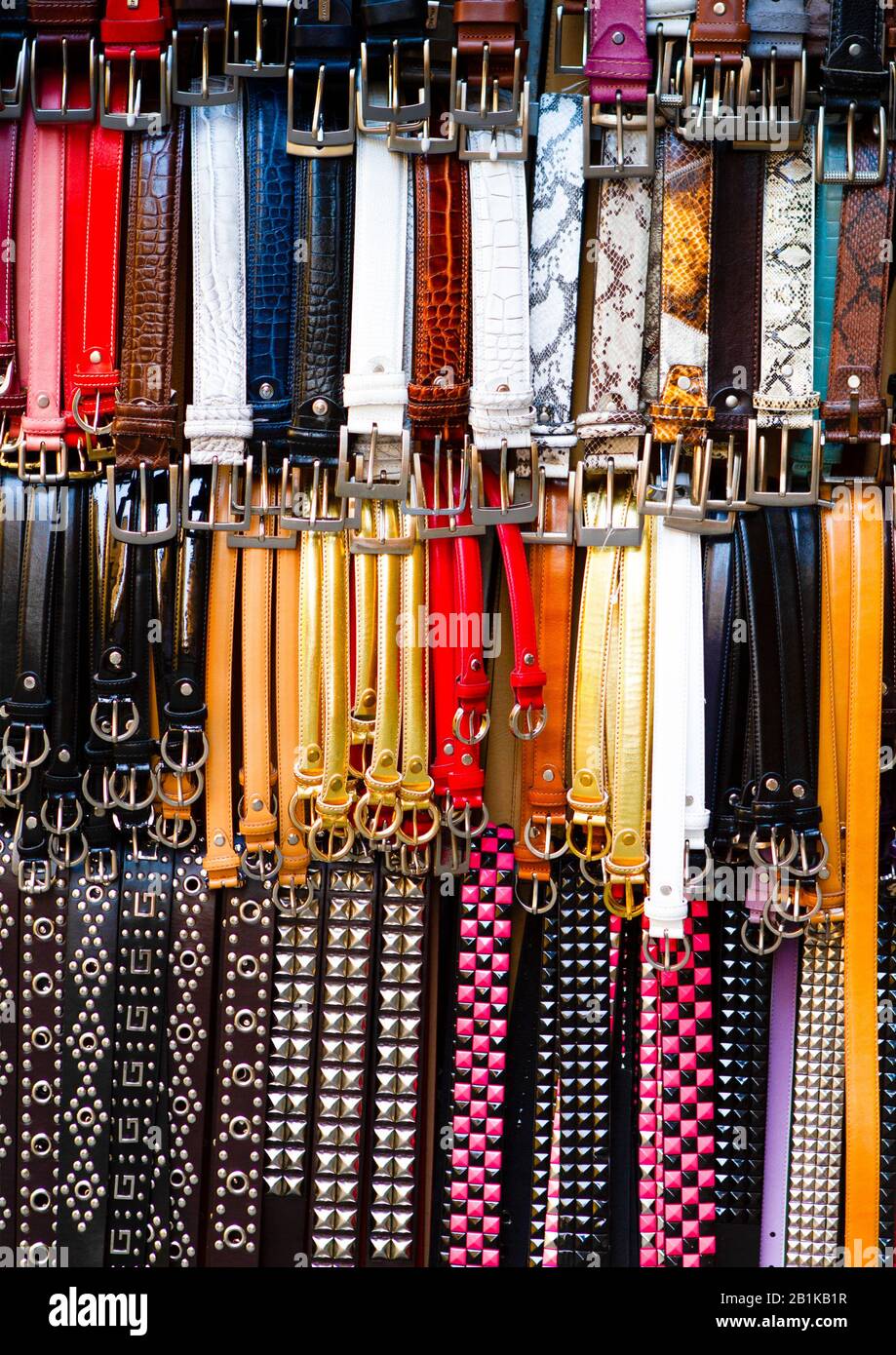 Leather belts in various colors. Vertical photo. Different styles Stock Photo
