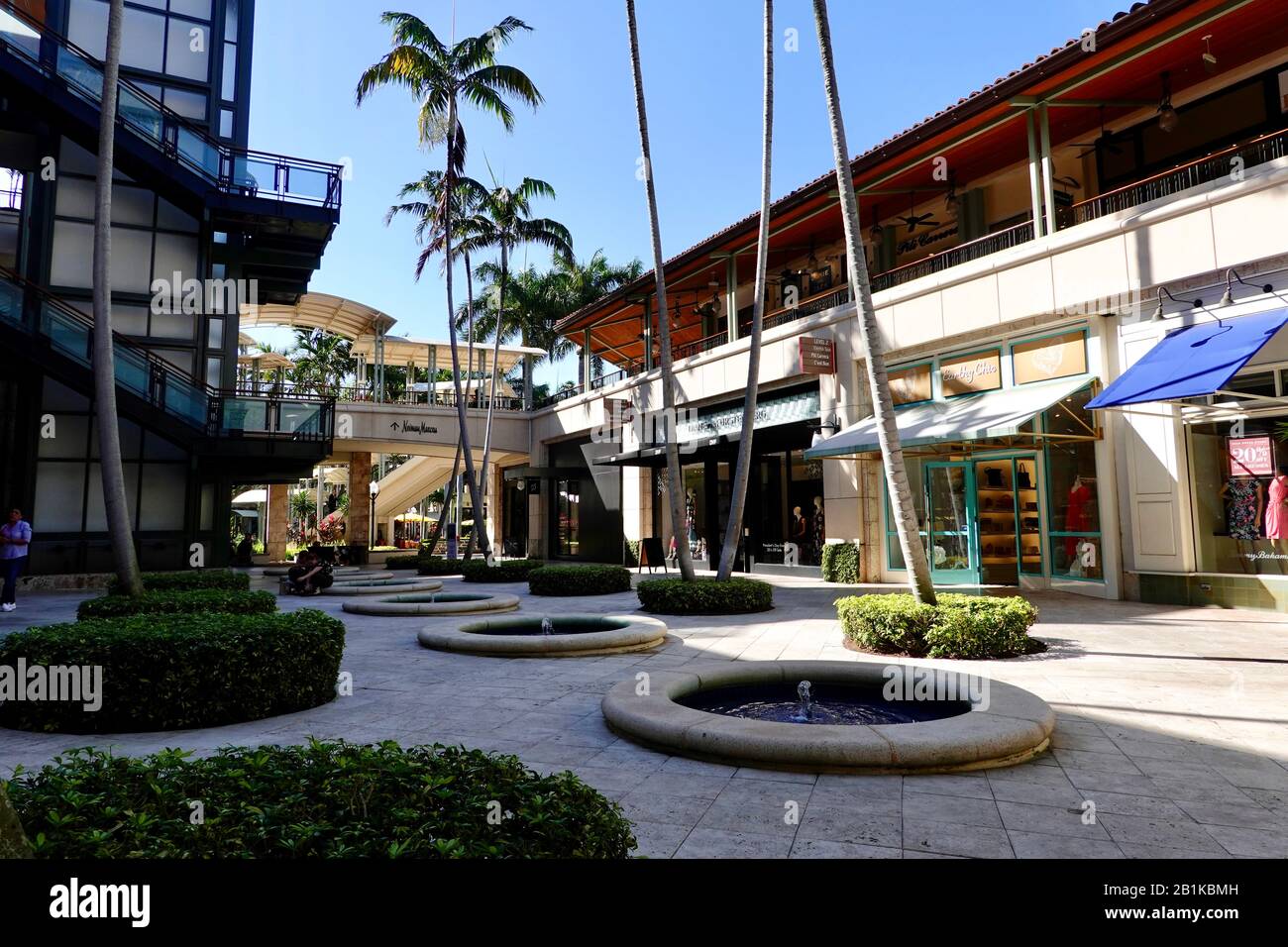 A few people in a paved, courtyard area of the Shops at Merrick Park, an upscale outdoor mall in Coral Gables, Miami, Florida, USA. Stock Photo