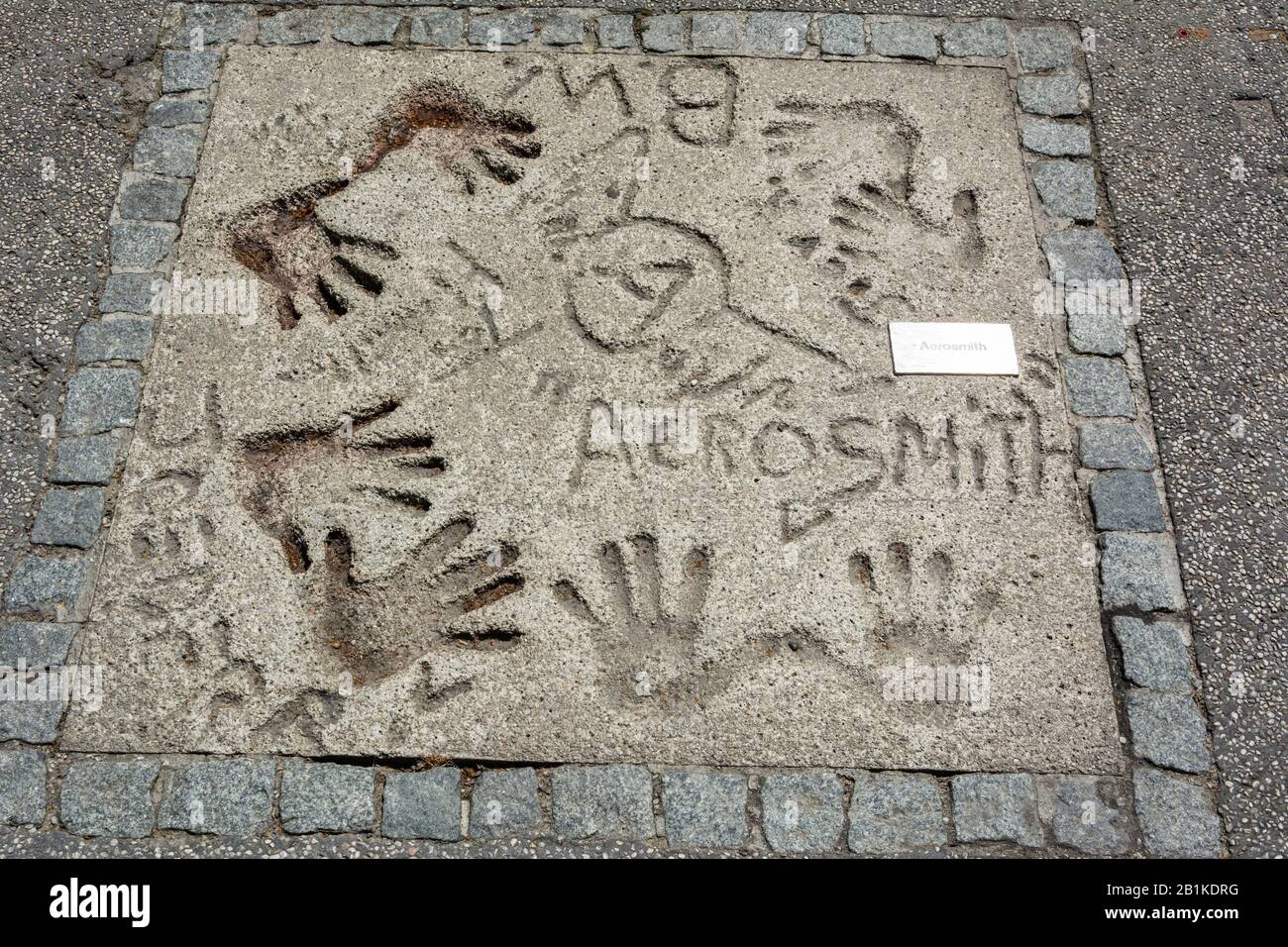 Munich, Germany – July 1, 2016. Mark of American rock band Aerosmith with hands and signets in the concrete at the Olympic Walk of Stars in Munich. Stock Photo