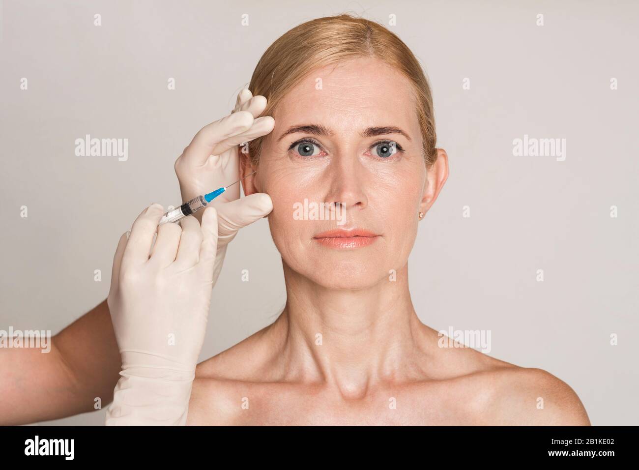 Plastic Surgery. Middle Aged Woman Receiving Botox Injection Stock