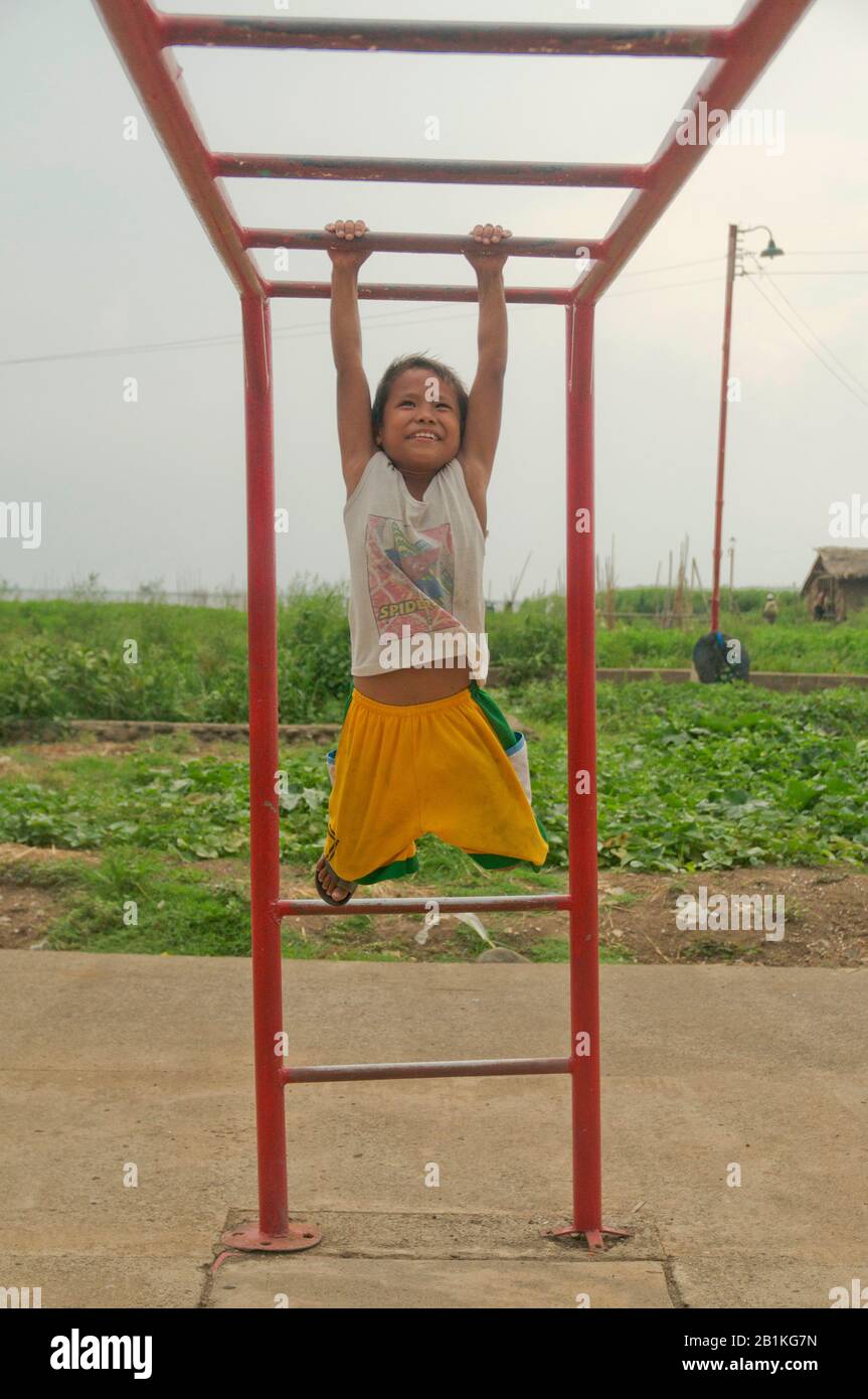 A jungle gym in a rice drying facility in Los Banos, Laguna, allows the children of rice farmers to use the playgrounds and develop physical strength. Stock Photo