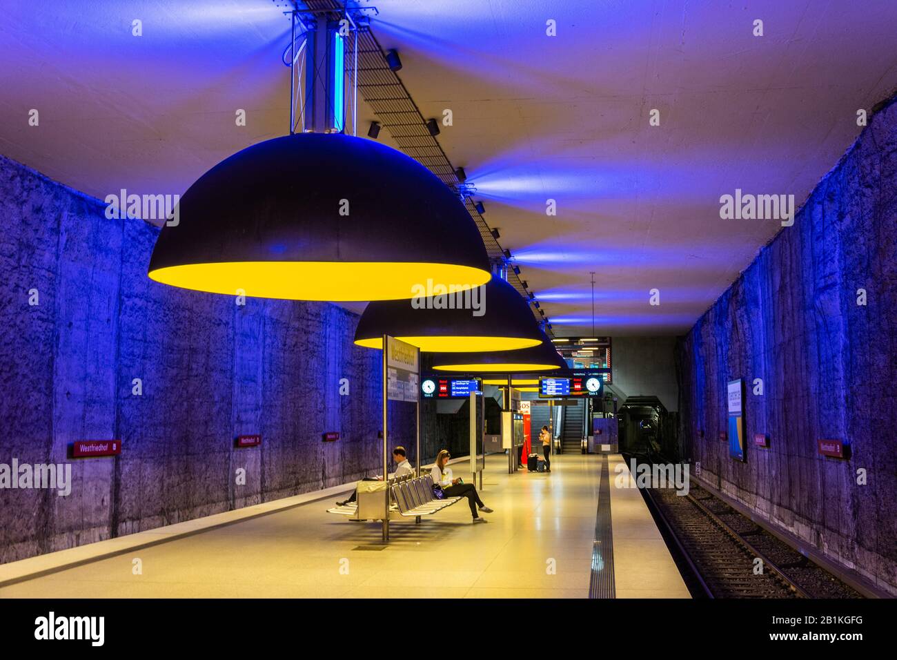 Munich, Germany – July 1, 2016. Interior view of Westfriedhof U-Bahn station on the U1 line of the Munich U-Bahn system, with people and information b Stock Photo
