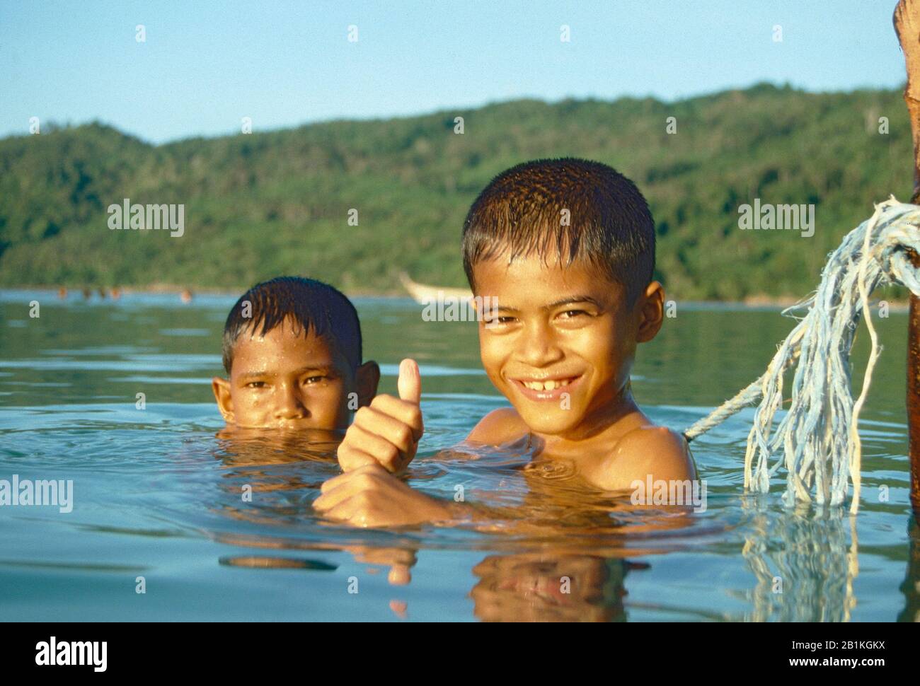 Portrait of Sea Gypsy (Moken) boys swimming in bay at Koh Phi Phi Island Thailand. Stock Photo