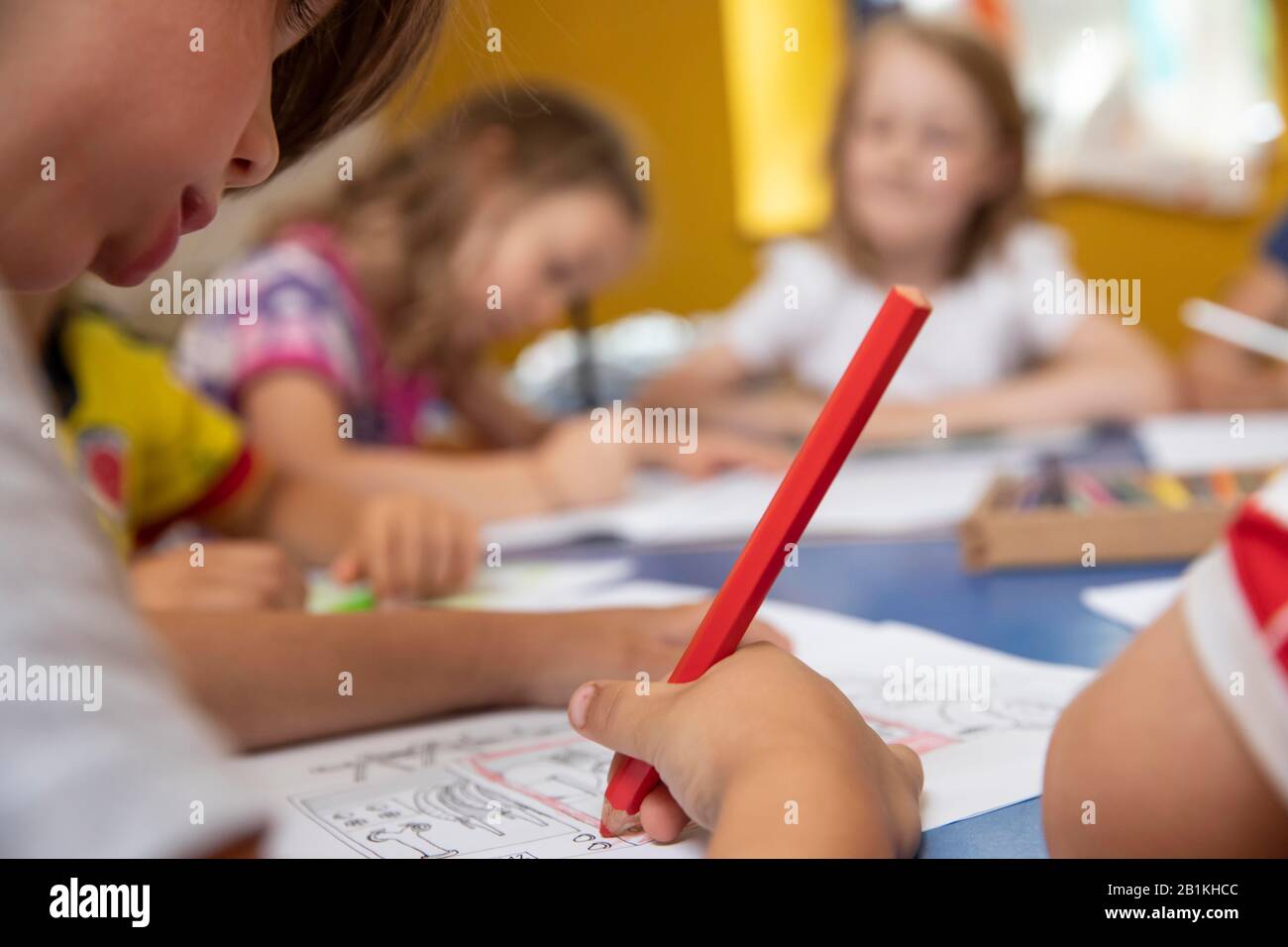 Children painting in kindergarten with crayons, Cologne, North Rhine ...