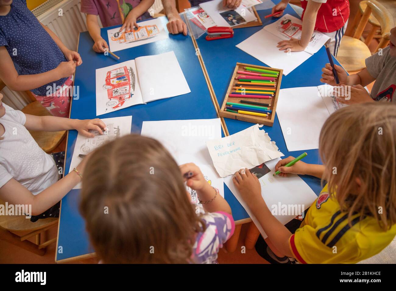 Children painting in kindergarten with crayons, Cologne, North Rhine ...