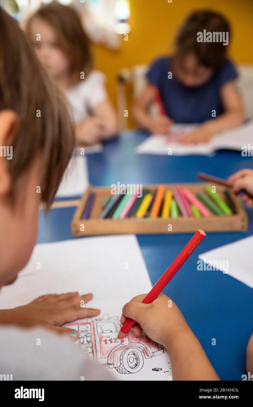 Children painting in kindergarten with crayons, Cologne, North Rhine ...