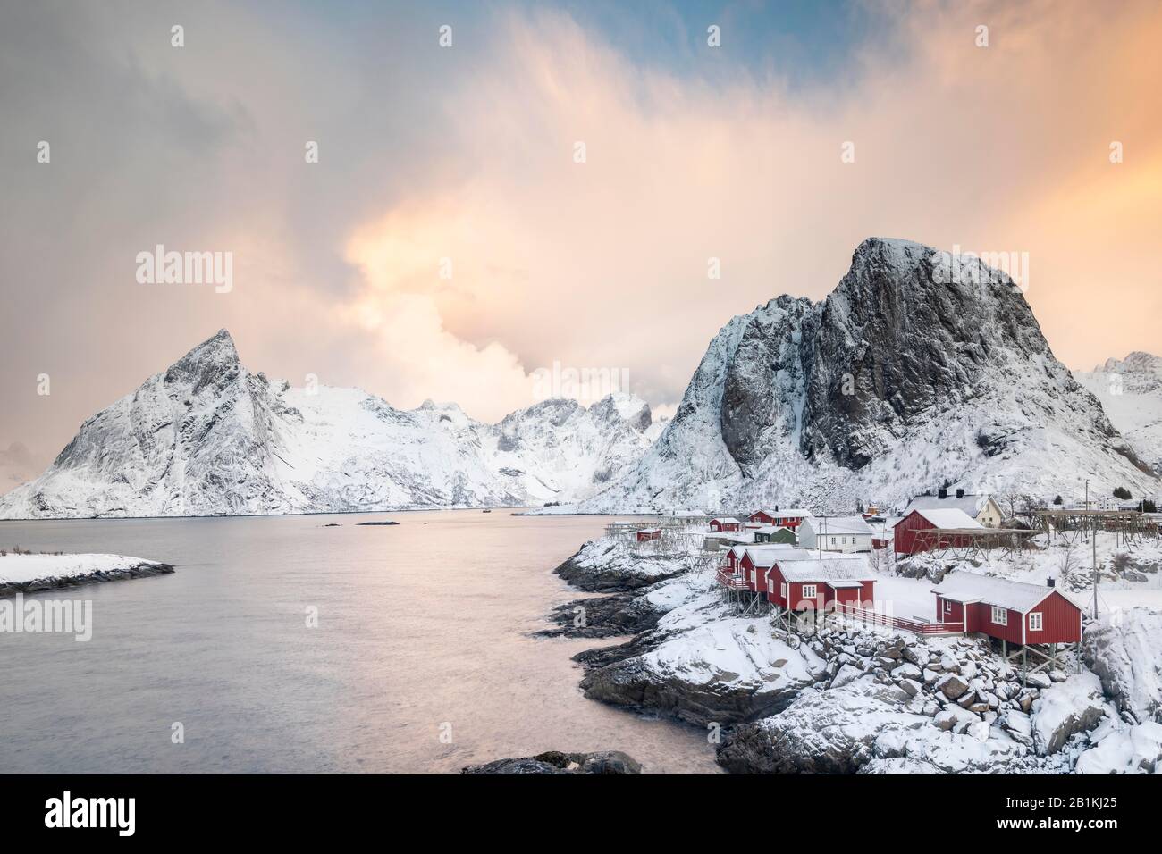 Rorbuer fishermen's cabins by the snowy fjord, Hamnoya, Moskenesoy, Lofoten, Norway Stock Photo