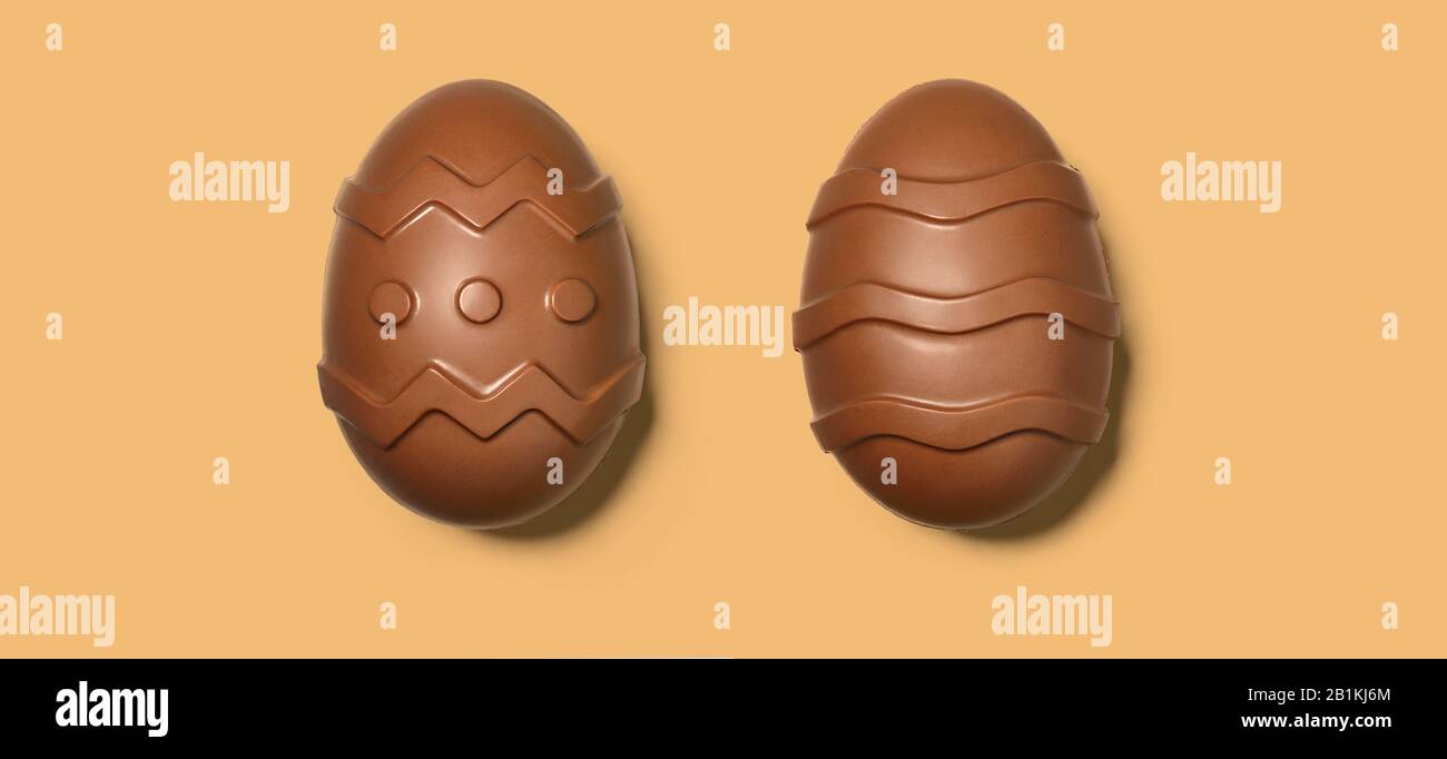 Chocolate Easter eggs on beige background, close up view Stock Photo