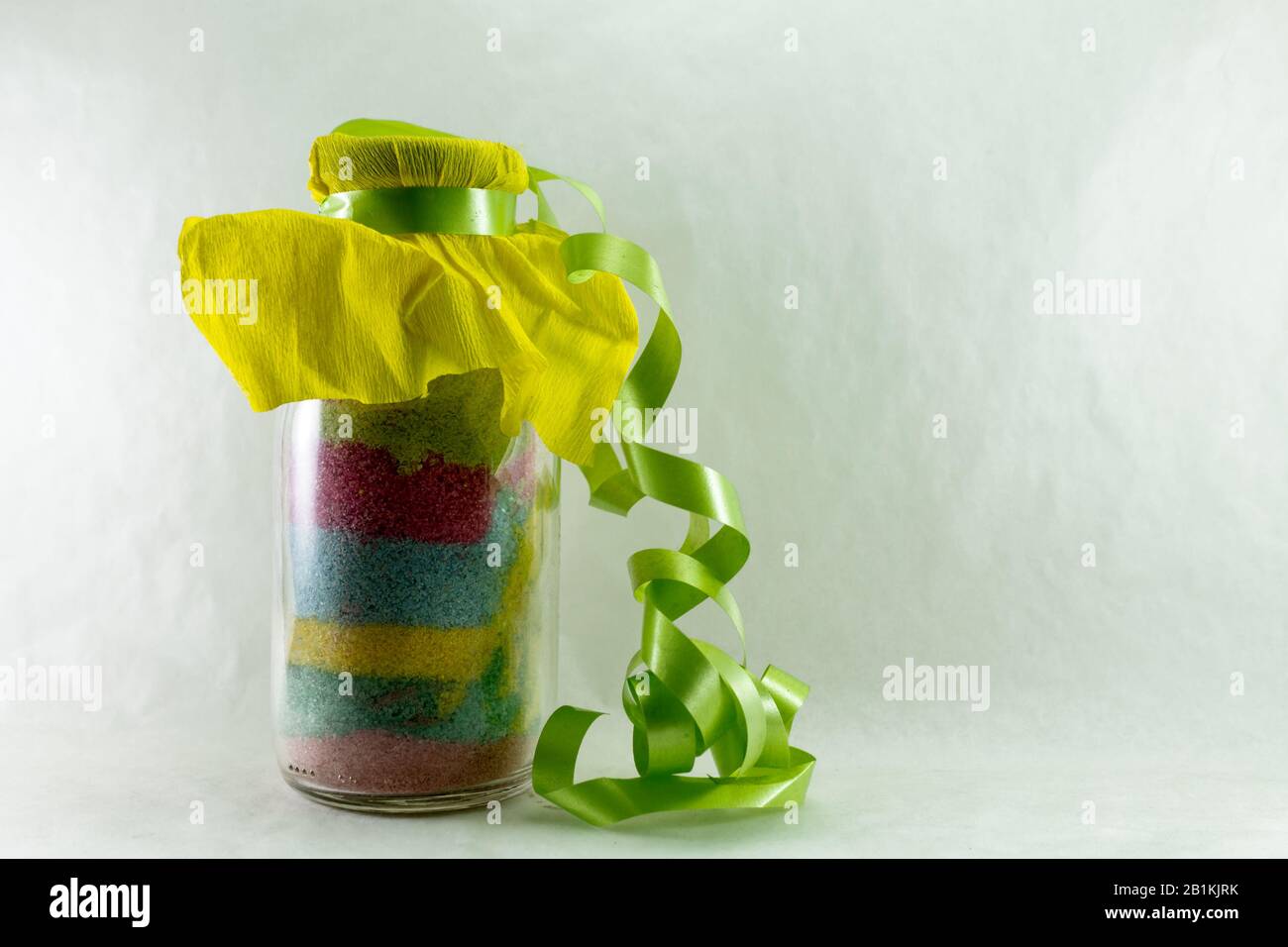 colored sand jar with gift ribbon Stock Photo Alamy