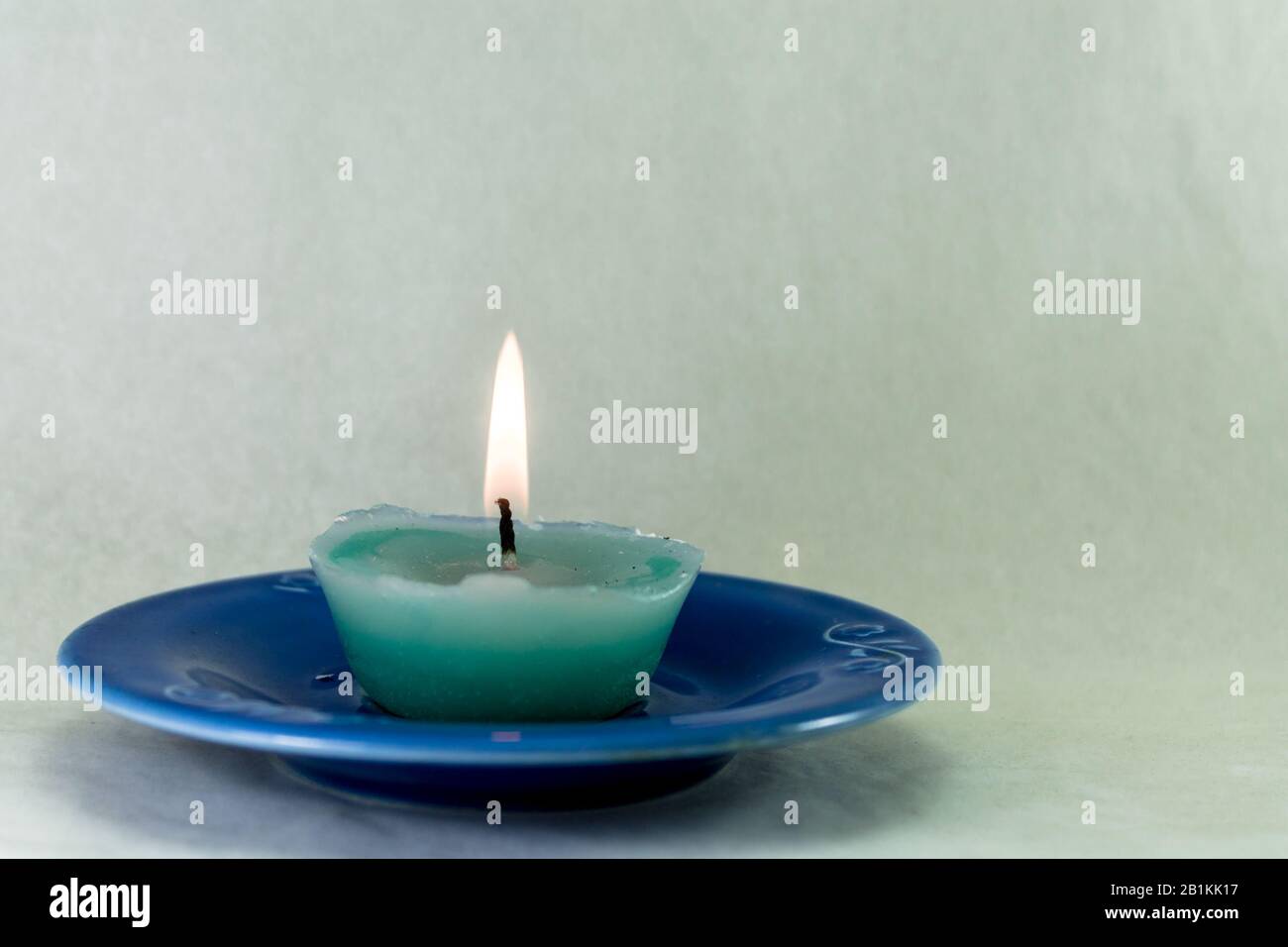 wax candle on a saucer Stock Photo Alamy