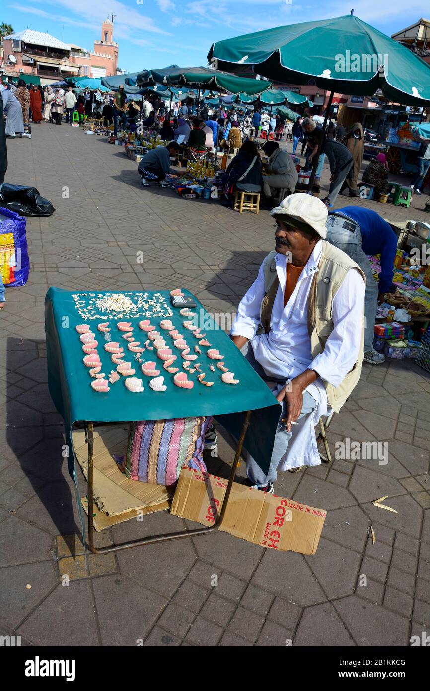 Maroc - November 23th 2014: Unidentified man on Djemaa el-Fna square, a dentist as street vendor with different sets of teeth Stock Photo
