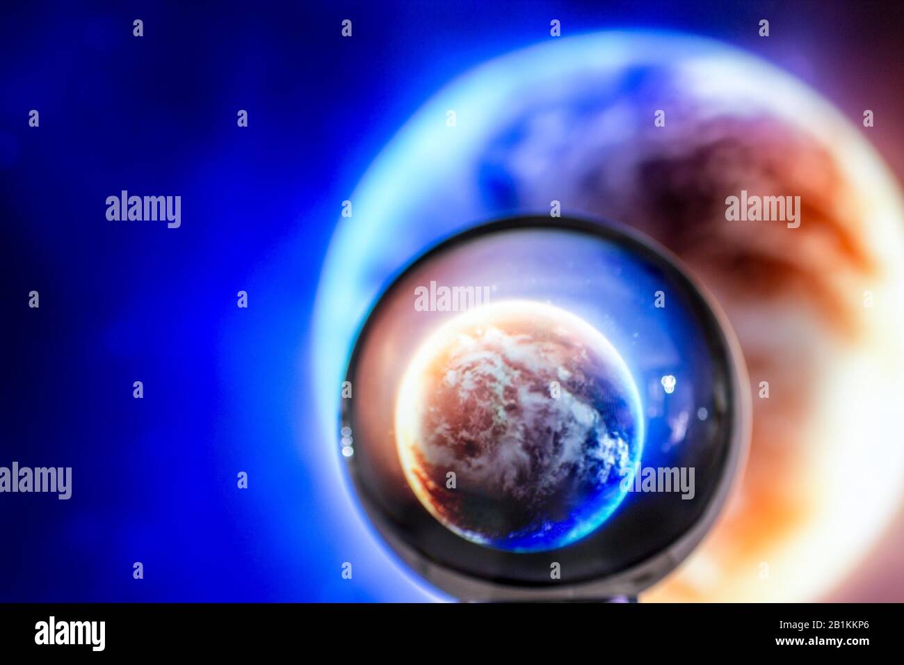 Earth sphere background with magnifying glass Stock Photo