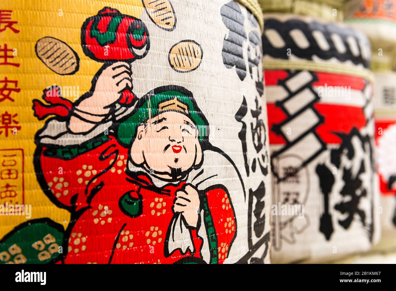 Sake barrels covered in Japanese art, at Kushida-jinja,  a Shinto shrine. Hakata-ku Old Town, Fukuoka. Japan Stock Photo