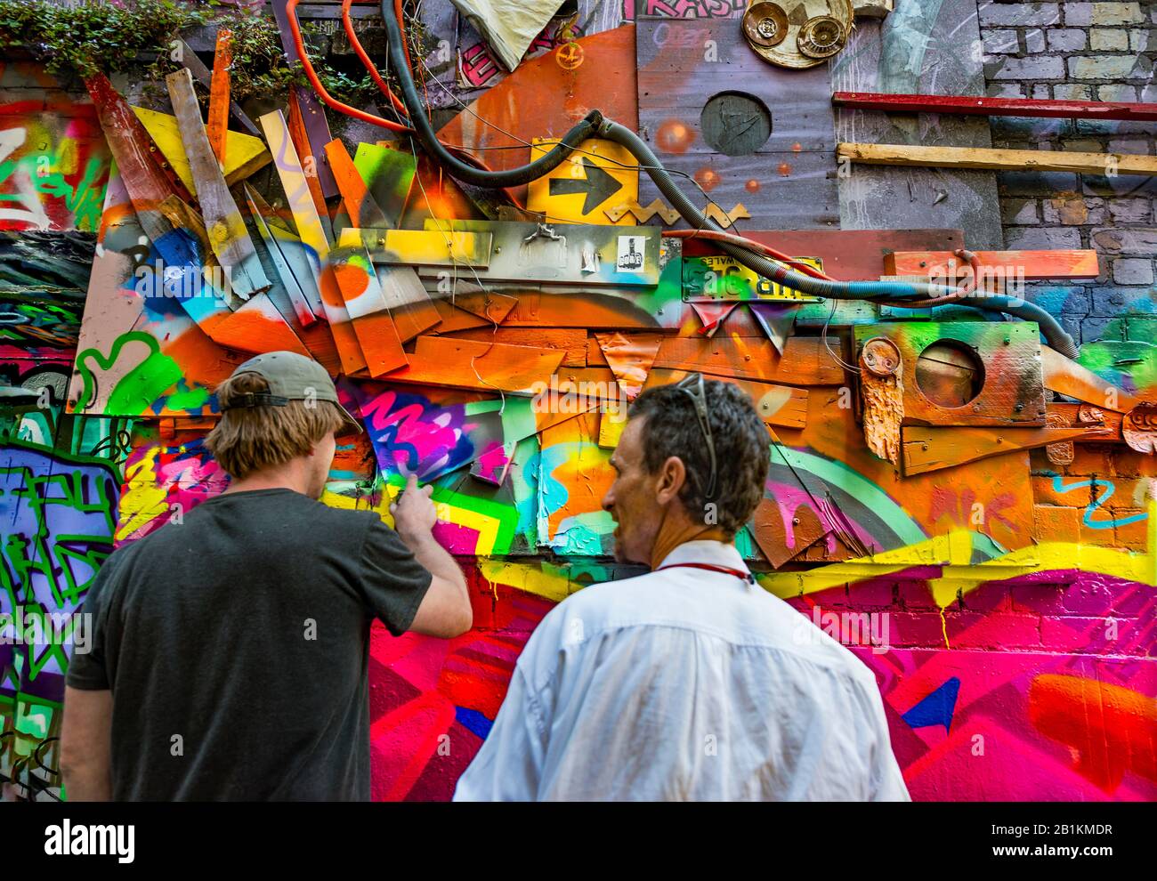 Two graffiti artists working on urban artwork, down graffiti filled alley ways, Hosier Street, Melbourne Lanes, Melbourne, Victoria, Australia Stock Photo