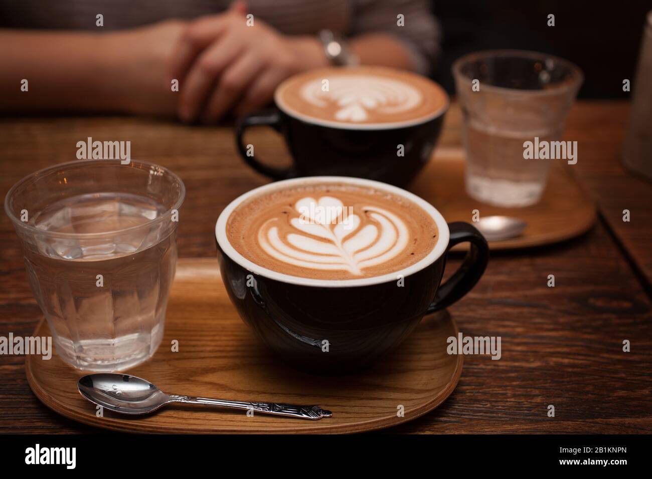 Two Mocha coffees with water served at a cafe Stock Photo