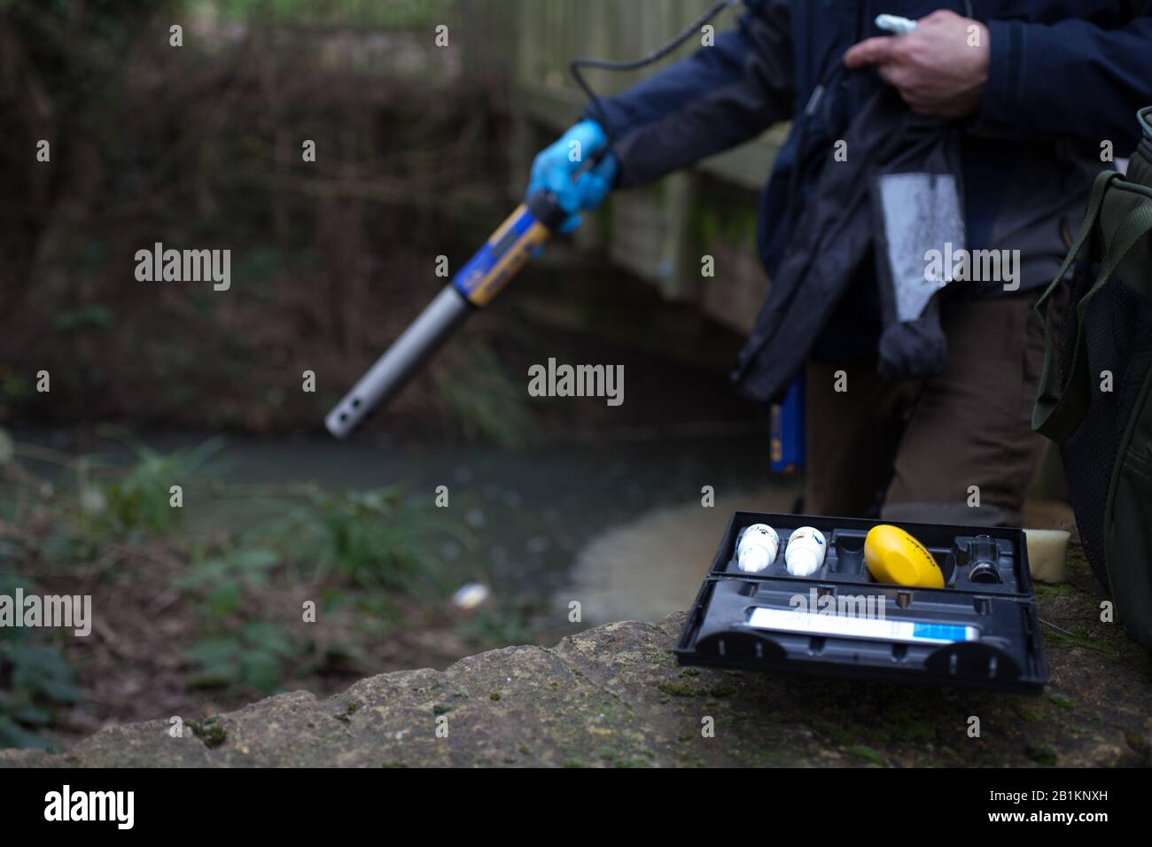 The Madley Brook river is tested for pollution in Witney, West Oxfordshire, UK Stock Photo
