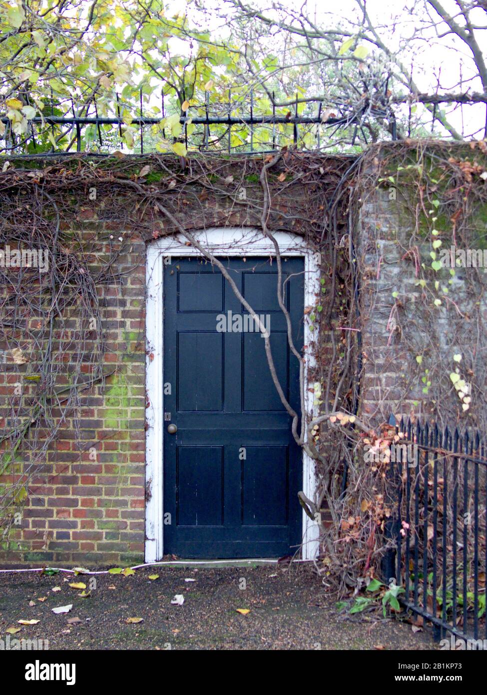 Black doorway used by Princess Diana, Prince William and Prince Harry for secret visits to Kensington Gardens. Kensington Palace, London, England. Stock Photo