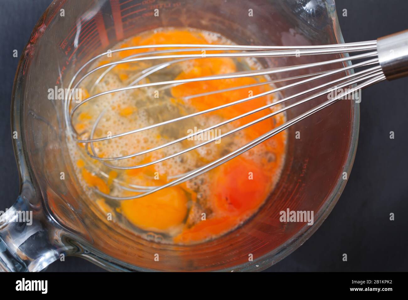 Beating 4 eggs with a hand whisk Stock Photo Alamy
