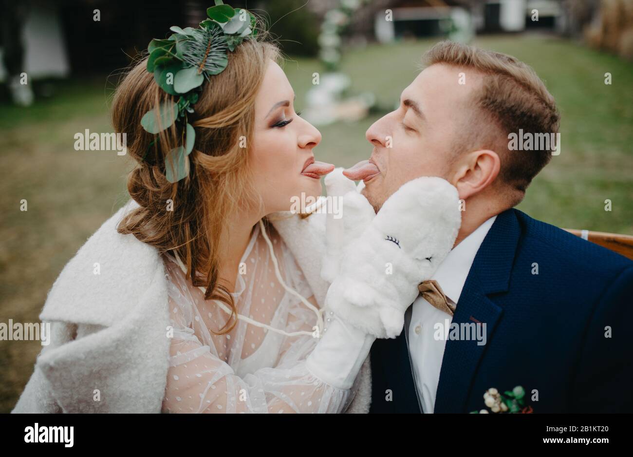 Newlyweds have a fun, frolic and show each other tongue. Closeup. Stock Photo