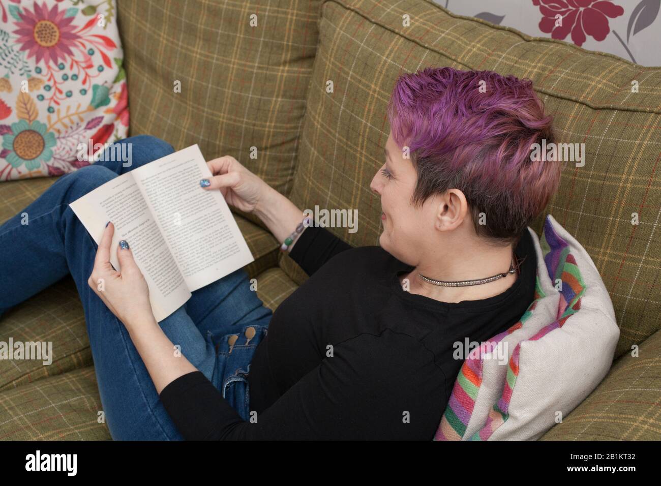 A woman reading a book about affirmations Stock Photo