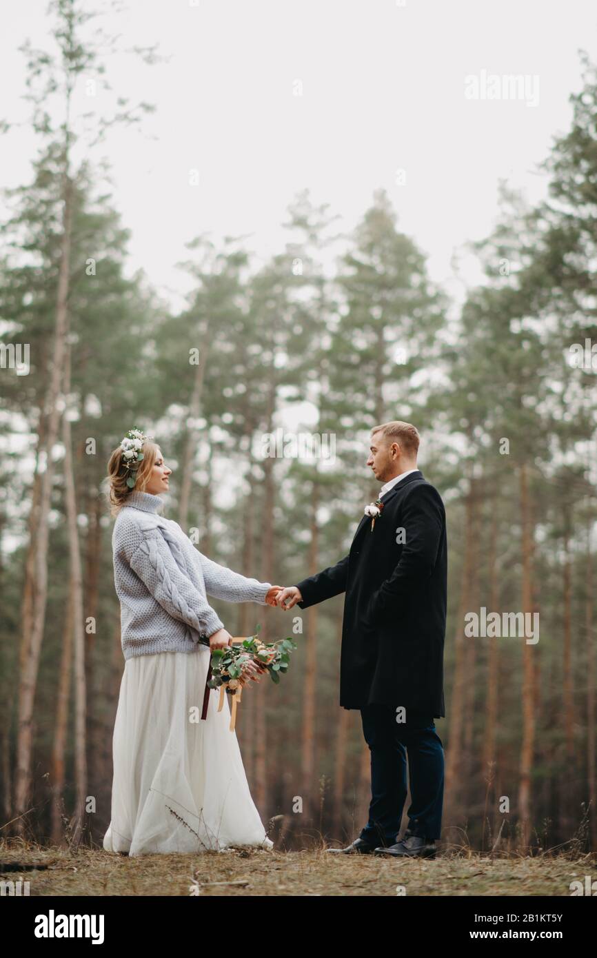 Happy newlyweds hold hands hi-res stock photography and images - Alamy
