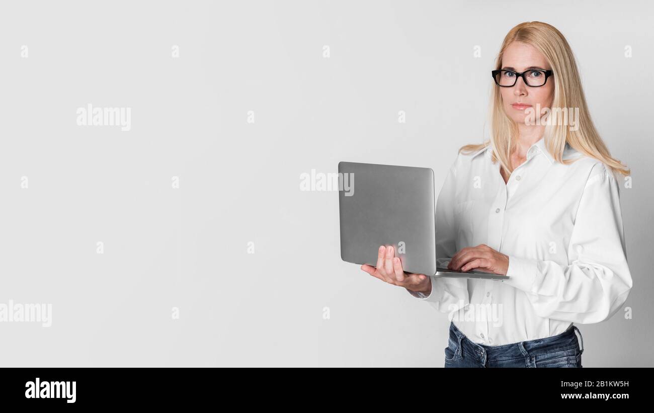 Confident mature woman typing hi-res stock photography and images - Alamy